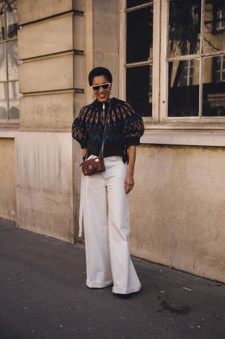 Tamu McPherson in white baggy jeans and a puff sleeve sweater