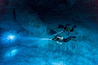 Divers Susan Bird and Alberto Nava search the walls of Hoyo Negro, an underwater cave on Mexico's Yucatan Peninsula where the remains of "Naia," a 12,000- to 13,000-year-old teenage girl, were found.