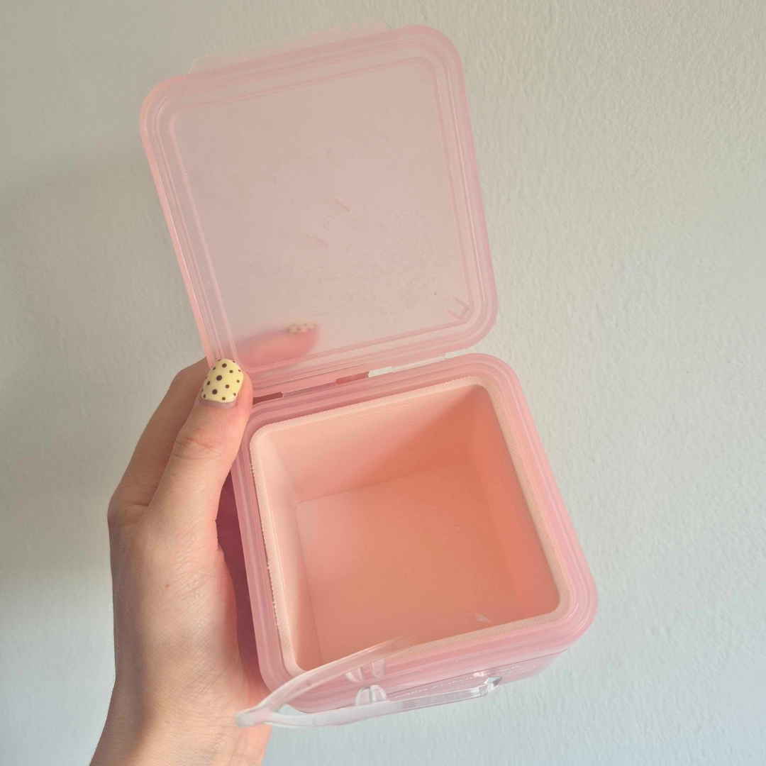 Hand holding an empty tub of Mediheal Collagen Ampoule Pad 100 Pads