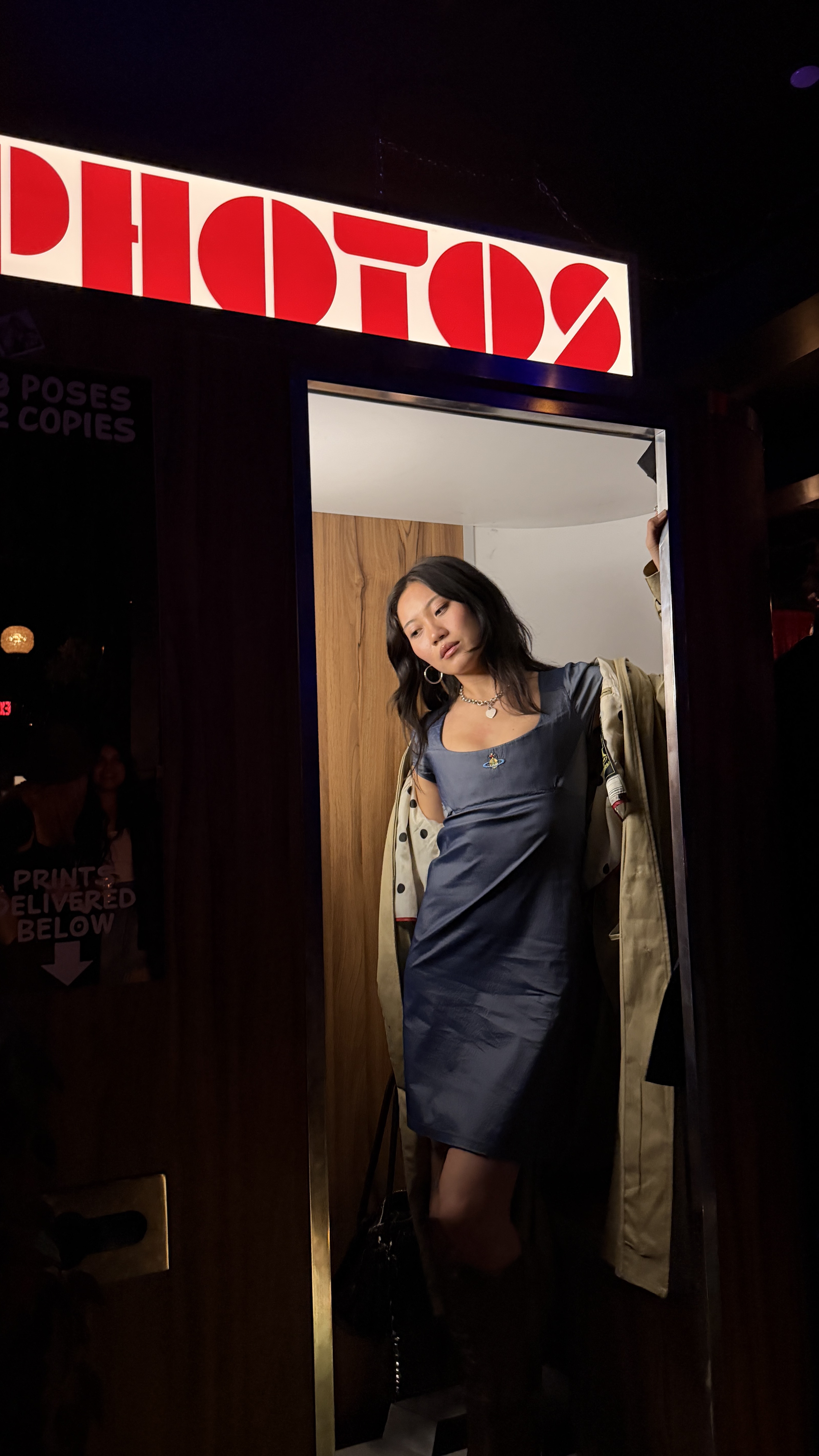 Vivian Li standing in a photo booth wearing a blue dress