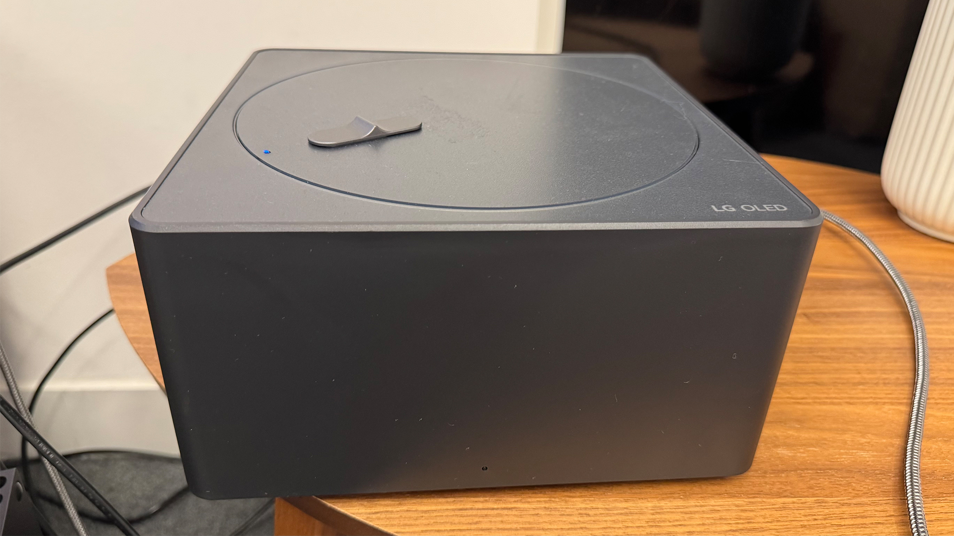 The Zero Connect Box of the 65-inch LG M5 OLED TV, pictured on a wooden table.