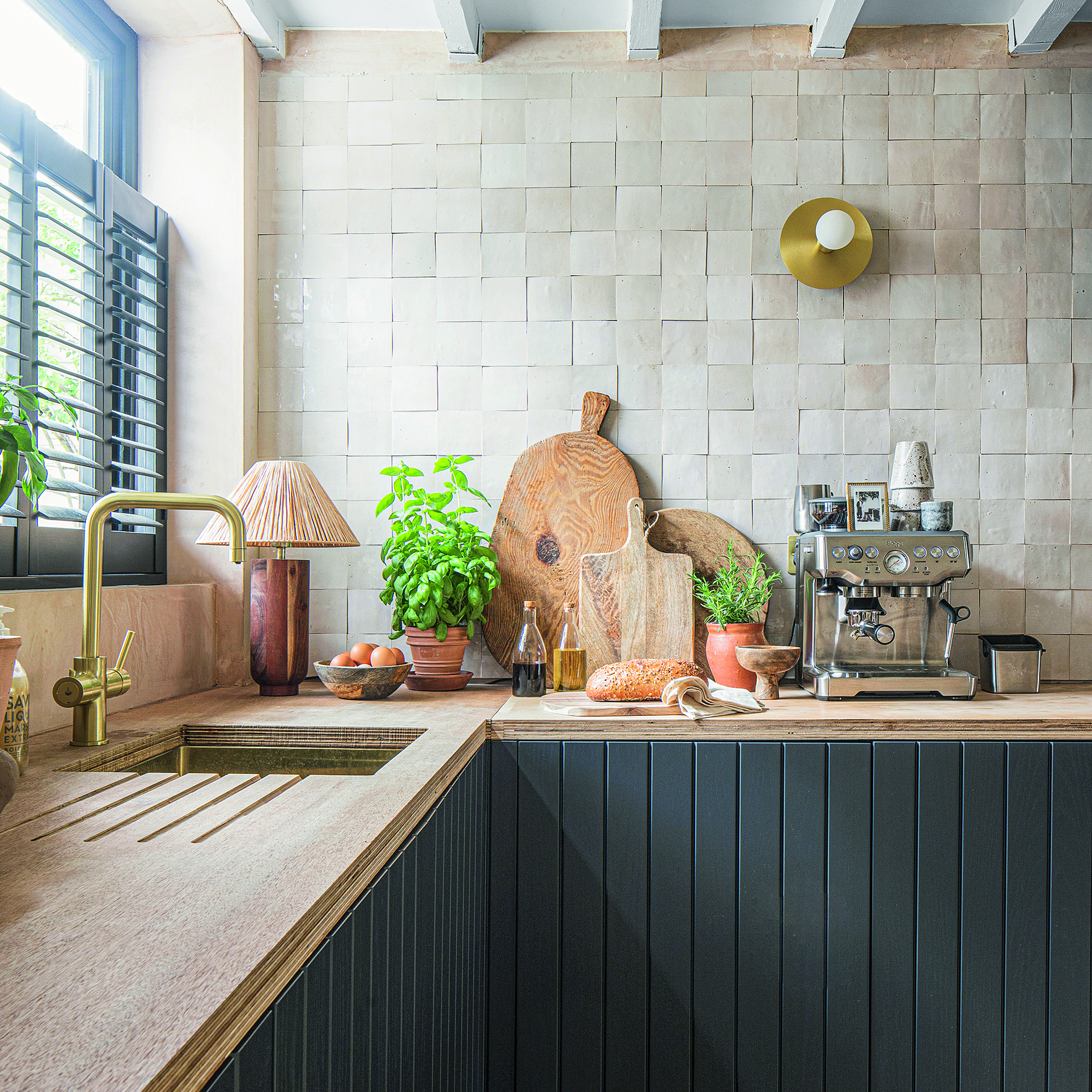 Kitchen with lots of accessories on worktop