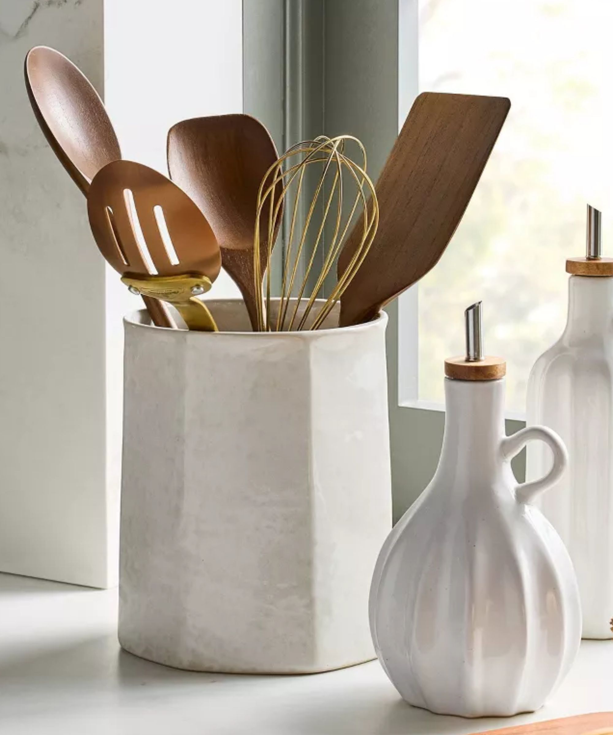 White stoneware utensil holder and ribbed oil cruets