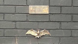 The brass plaque and bat attached to the wall of The Crown, Birmingham