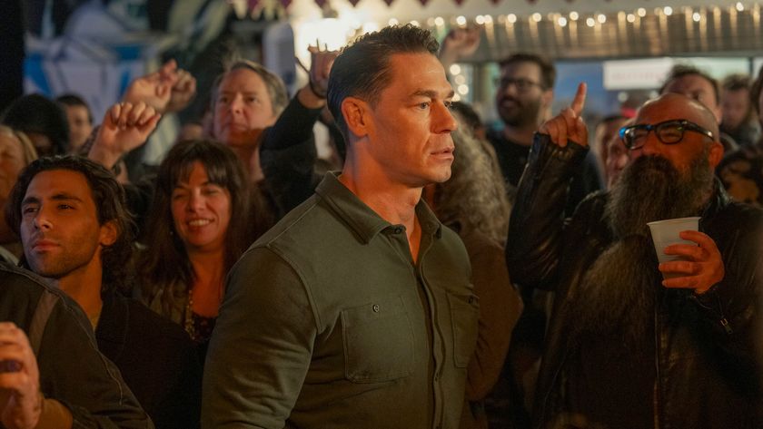 John Cena as Peacemaker in the Peacemaker season 2 finale, surrounded by a crowd of people.