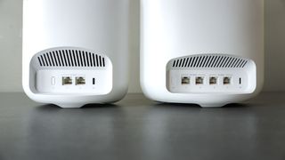 The eero Pro 7 next to the eero Max 7 on a desk showing off their rear ports