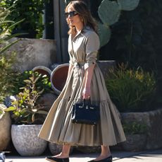 Jennifer Lopez in black Repetto ballet flats and a tan shirt dress