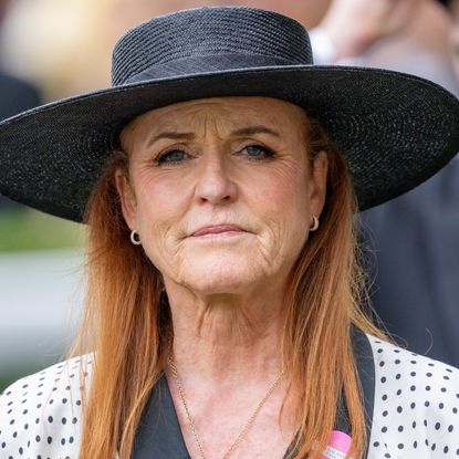 Sarah Ferguson attending Ascot 2025 wearing a black and white polka dot dress with a wide-brim black hat, she has red hair