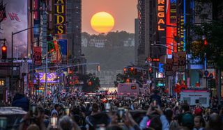 The Sun sets in alignment with Manhattan streets running east-west, also known as Manhattanhenge, in New York City on May 30, 2023. Manhattanhenge occurs about the same two days in May and then again on two days in July every year. (Photo by ED JONES/AFP via Getty Images)