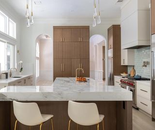 Kitchen with light wood flooring and light colored walls