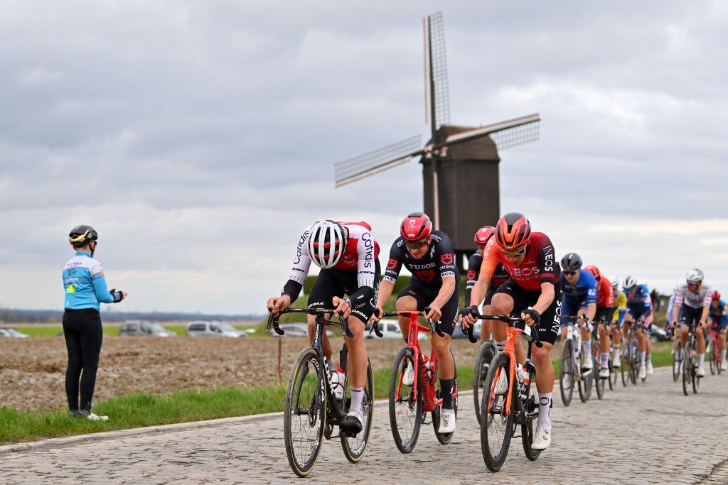 NOKERE BELGIUM MARCH 13 A general view of Ethan Hayter of The United Kingdom and Team INEOS Grenadiers and the peloton passing through a windmill farm during the 78th Danilith Nokere Koerse 2024 Mens Elite a 1881km one day race from Deinze to Nokere UCIWT on March 13 2024 in Nokere Belgium Photo by Luc ClaessenGetty Images