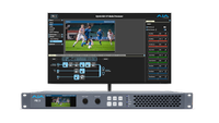 The new AJA FS8 in front of a monitor showcasing a soccer match.