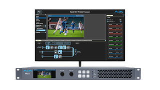 The new AJA FS8 in front of a monitor showcasing a soccer match.