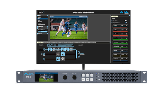 The new AJA FS8 in front of a monitor showcasing a soccer match.