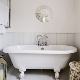 bathroom with white wall and white bathtub
