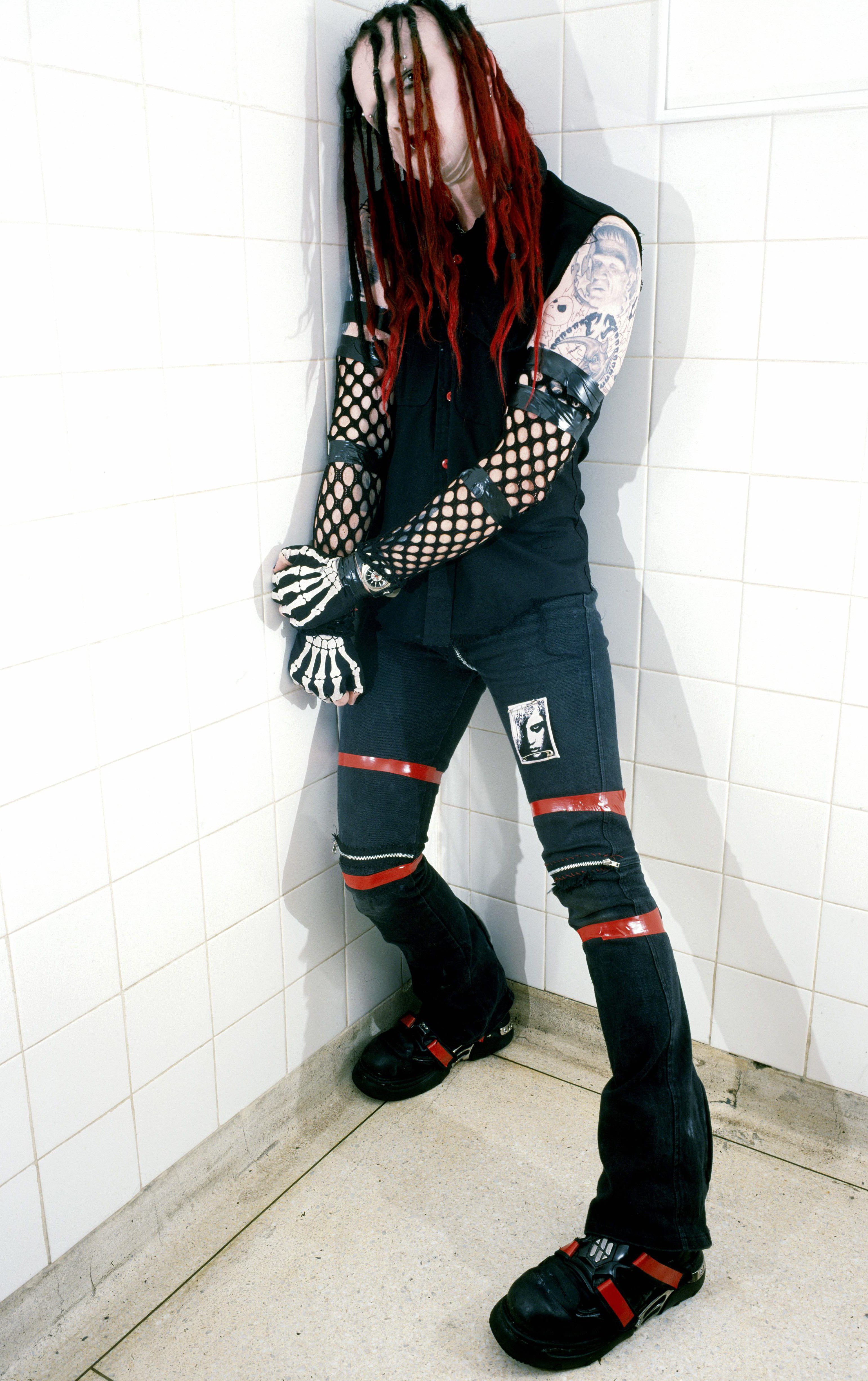 Murderdolls members posing in a public bathroom
