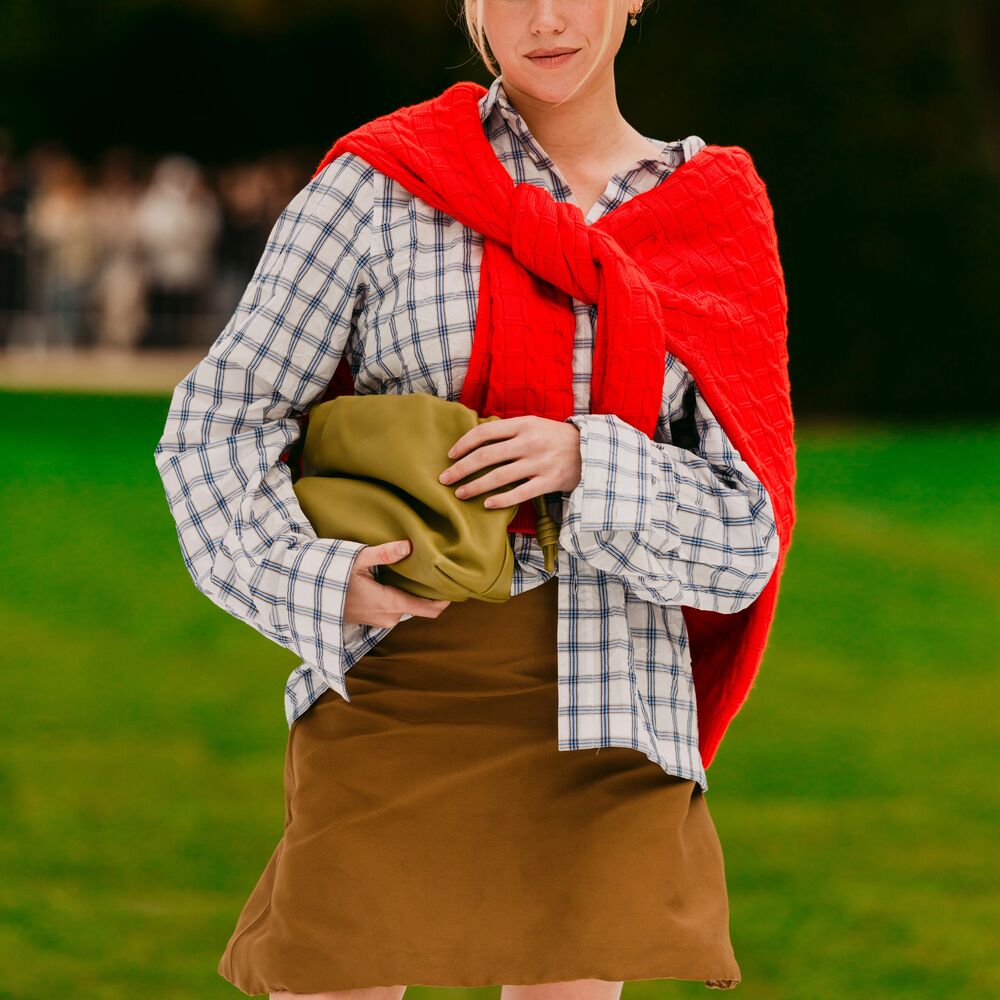 a woman wears a plaid shirt