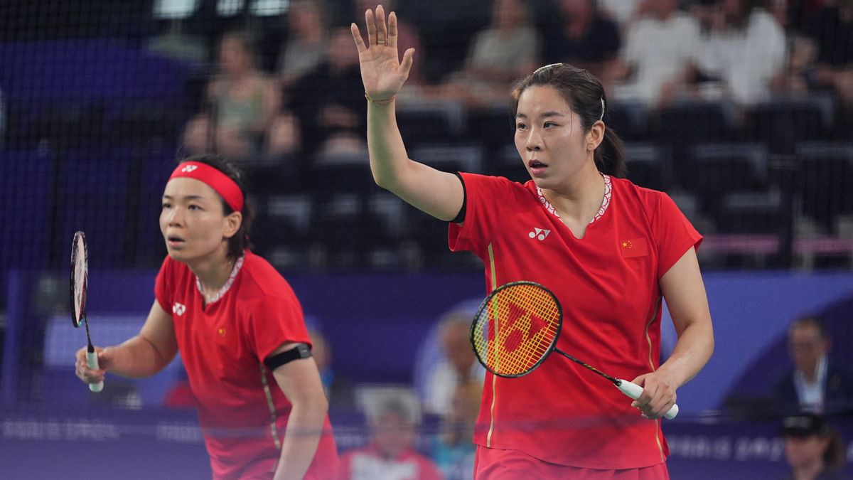 Chen Qingchen and Jia Yifan of Team China, in all red, compete in the women&#039;s doubles badminton at the Paris Olympic Games.