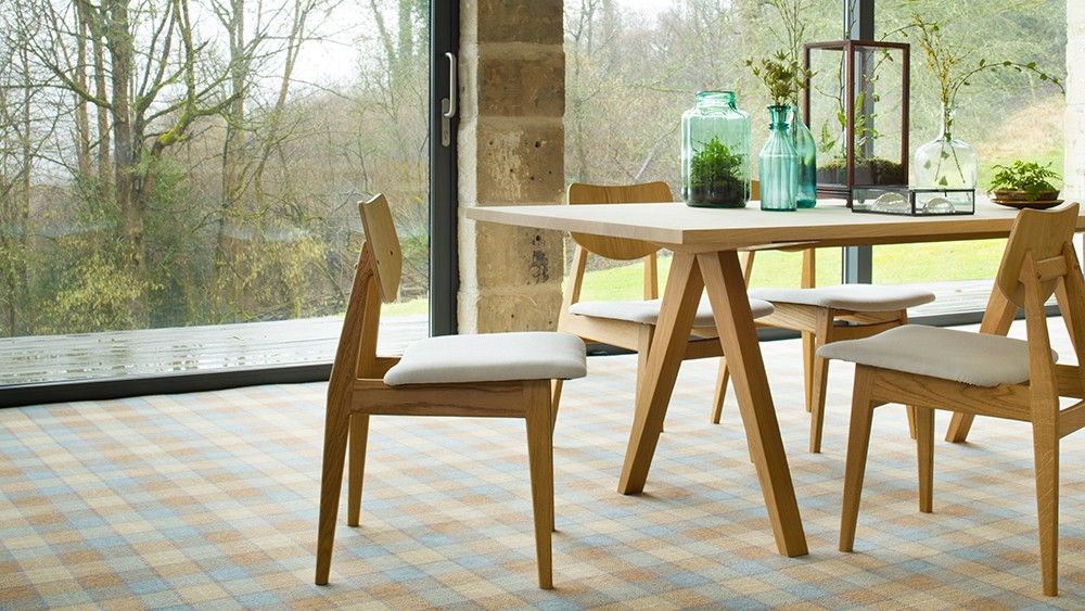 room with wooden chair table and glass vase