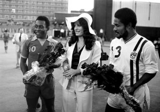 Pele and Eusebio receive flowers ahead of a game between NY Cosmos and Boston Minutemen in 1975.