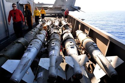 U.S. service members load missiles for anti-ISIS airstrikes