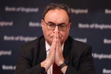 The Bank of England Governor Andrew Bailey with his hands together in front of his face.