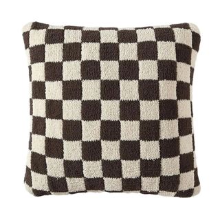 A dark brown and white checkered pillow