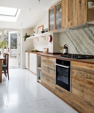 modern kitchen with wooden cabinetry and tiled floor