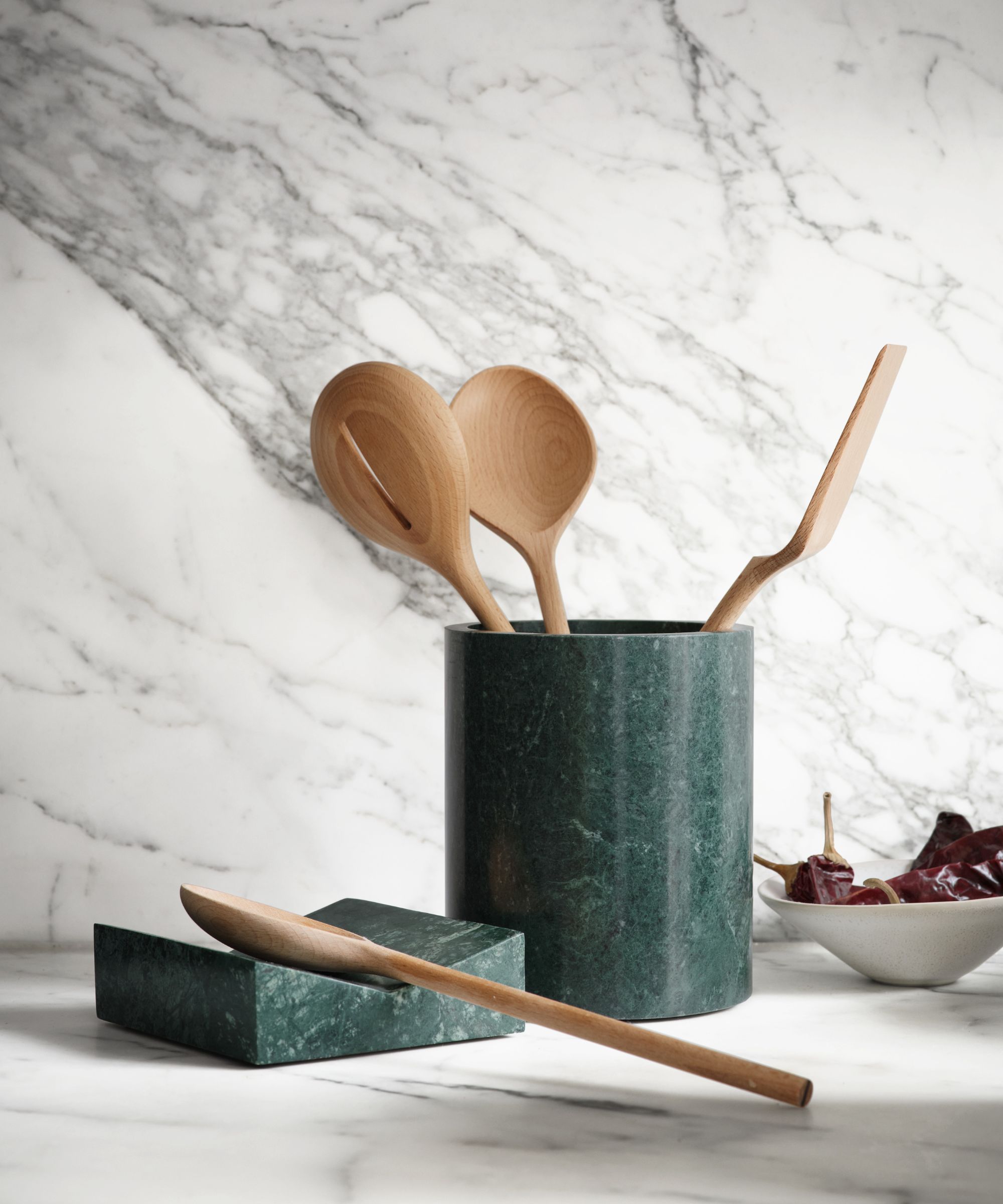 Green marble utensil pot and spoon rest with wooden utensils