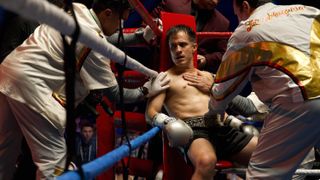 La Maquina (Gael Garcia Bernal) in the corner of the boxing ring attended by his team in "La Maquina" on Hulu