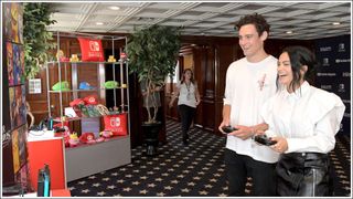 Camila Mendes (R) and Victor Houston test their skills on Super Smash Bros. Ultimate for Nintendo Switch at the Variety Studio at Comic-Con 2018 on July 21, 2018 in San Diego, California.