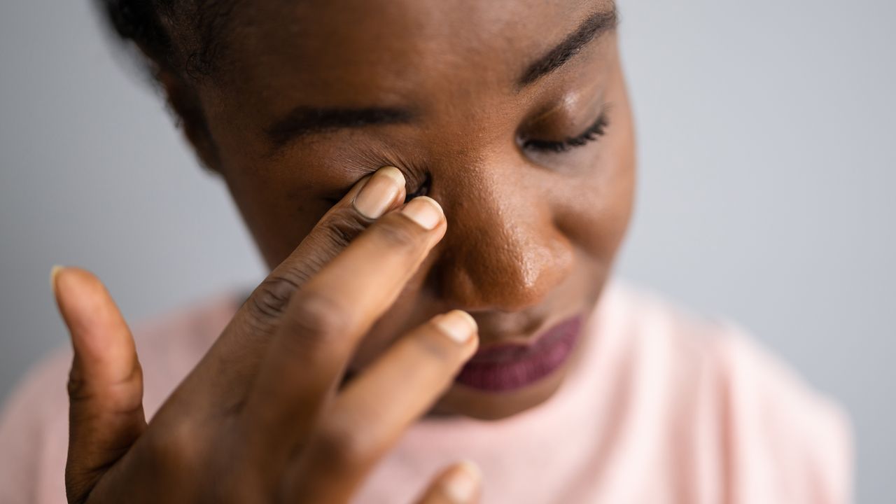 Women scratches her eye