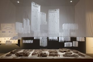 Alison Brooks installation at the 2021 Venice architecture biennale showing a monumental table into which sixteen architectural models are cast as a participatory ‘conversation piece’