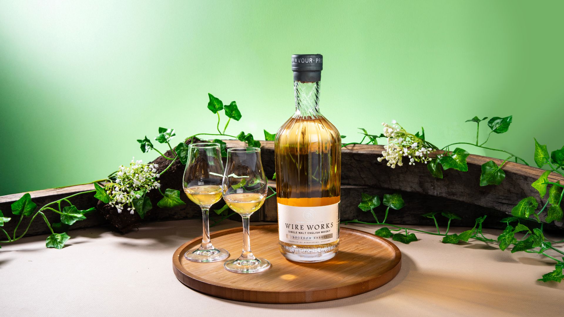 an image of the wire works whisky bottle with two poured drams next to it