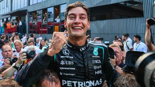 George Russell of Great Britain and Mercedes AMG Petronas celebrates in the paddock following the group photo during the F1 Grand Prix of Austria