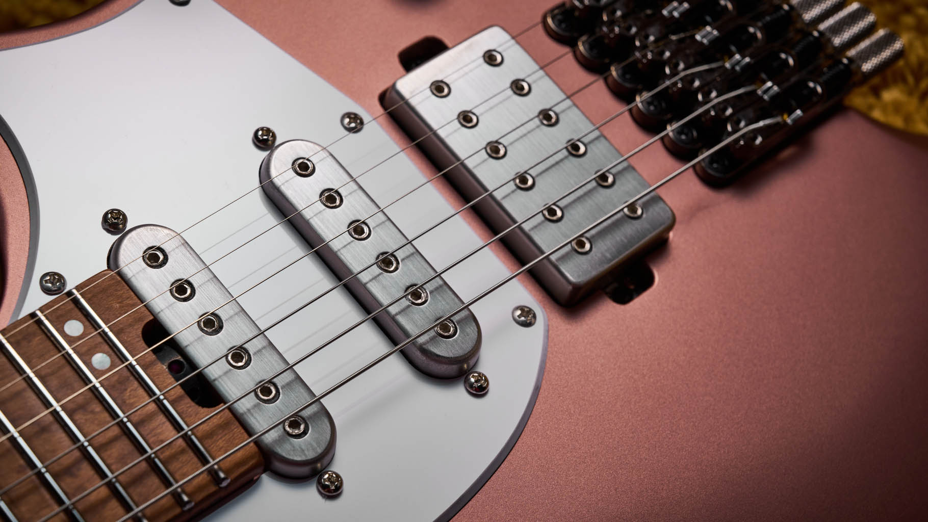 Ibanez Q54W: the headless electric guitar is finished in Copper Metallic Matte and photographed against a thick light-tan colored carpet.