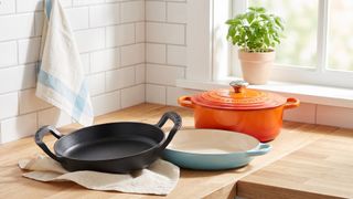 A selection of Le Creuset items in a kitchen setting.