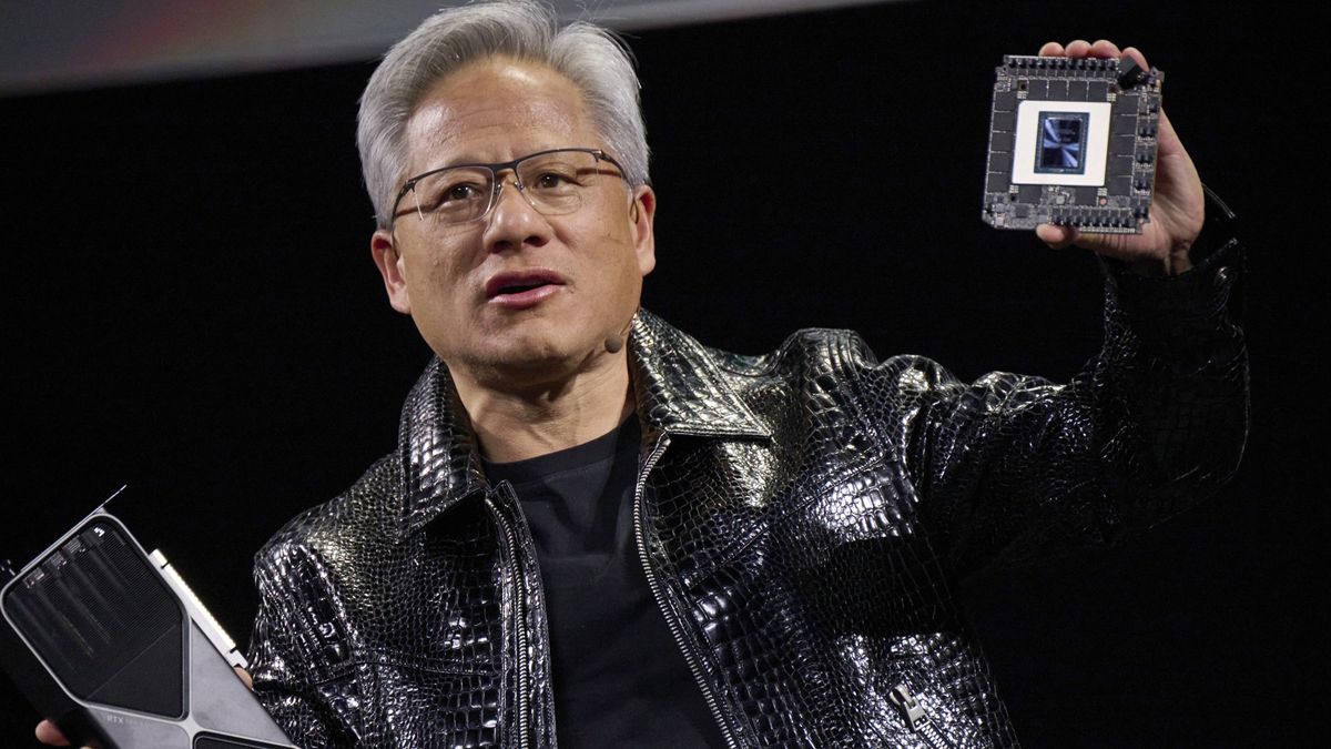 Jensen Huang, co-founder and chief executive officer of Nvidia Corp., speaks while holding the company&#039;s new GeForce RTX 50 series graphics cards and a Thor Blackwell robotics processor during the 2025 CES event in Las Vegas, Nevada, US, on Monday, Jan. 6, 2025. Huang announced a raft of new chips, software and services, aiming to stay at the forefront of artificial intelligence computing. Photographer: Bridget Bennett/Bloomberg via Getty Images