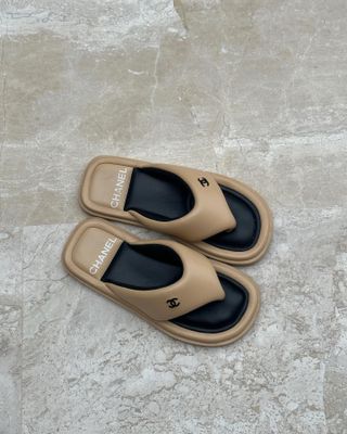 Beige Chanel flip-flops.