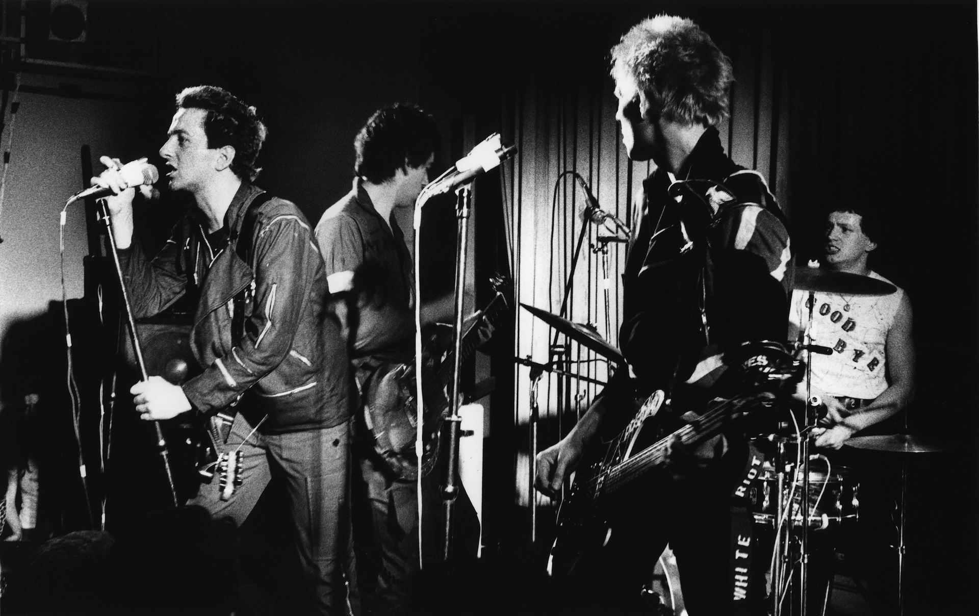 British punk group The Clash performing at the Coliseum, Harlesden, London, 11th March 1977. Left to right: Joe Strummer (1952 - 2002), Mick Jones, Paul Simonon and Terry Chimes. Chimes' 'Goodbye' T-shirt signals his departure from the band.