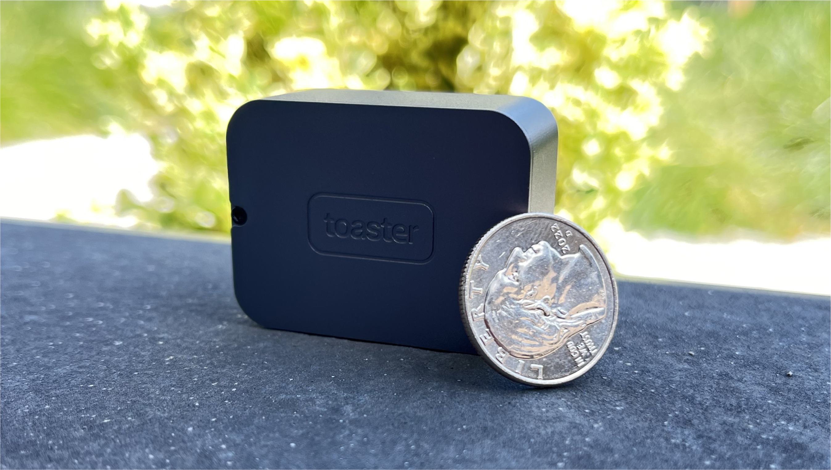 Toaster photon camera next to coin