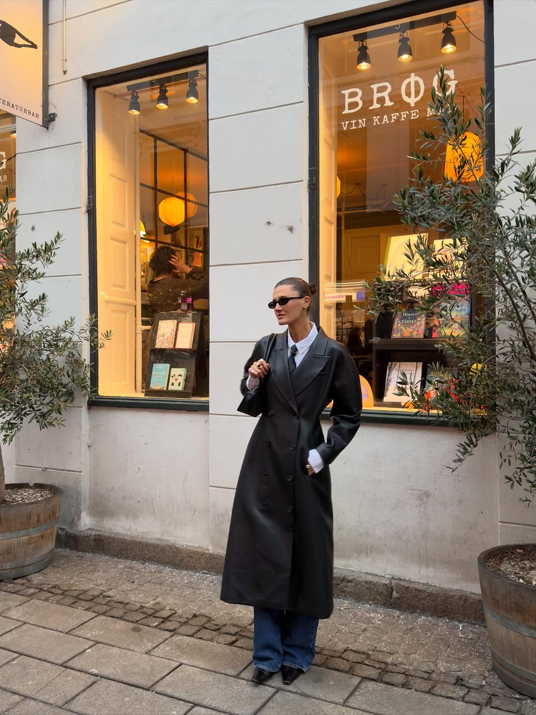 woman wearing leather trench coat jean outfit spring 2026