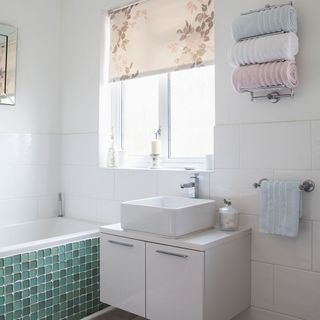 bathroom with sink and white tiles on wall