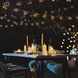 outdoor area with sparkle light and candle