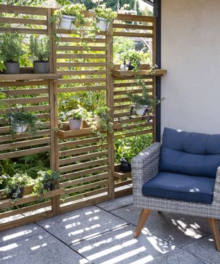 timber slatted screen used to add privacy to an outdoor seating area