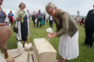 Sophie Wessex tries masonry at the Westmoreland County Show, chiselling a block of stone.