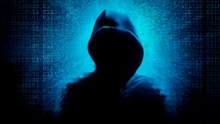 An image of a shadowed hooded hacker on a blue background