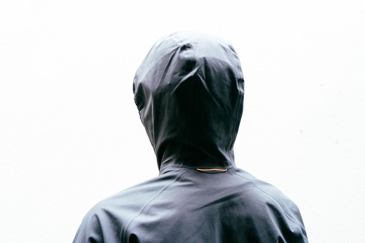 A close up of the rear of the hood of a black jacket