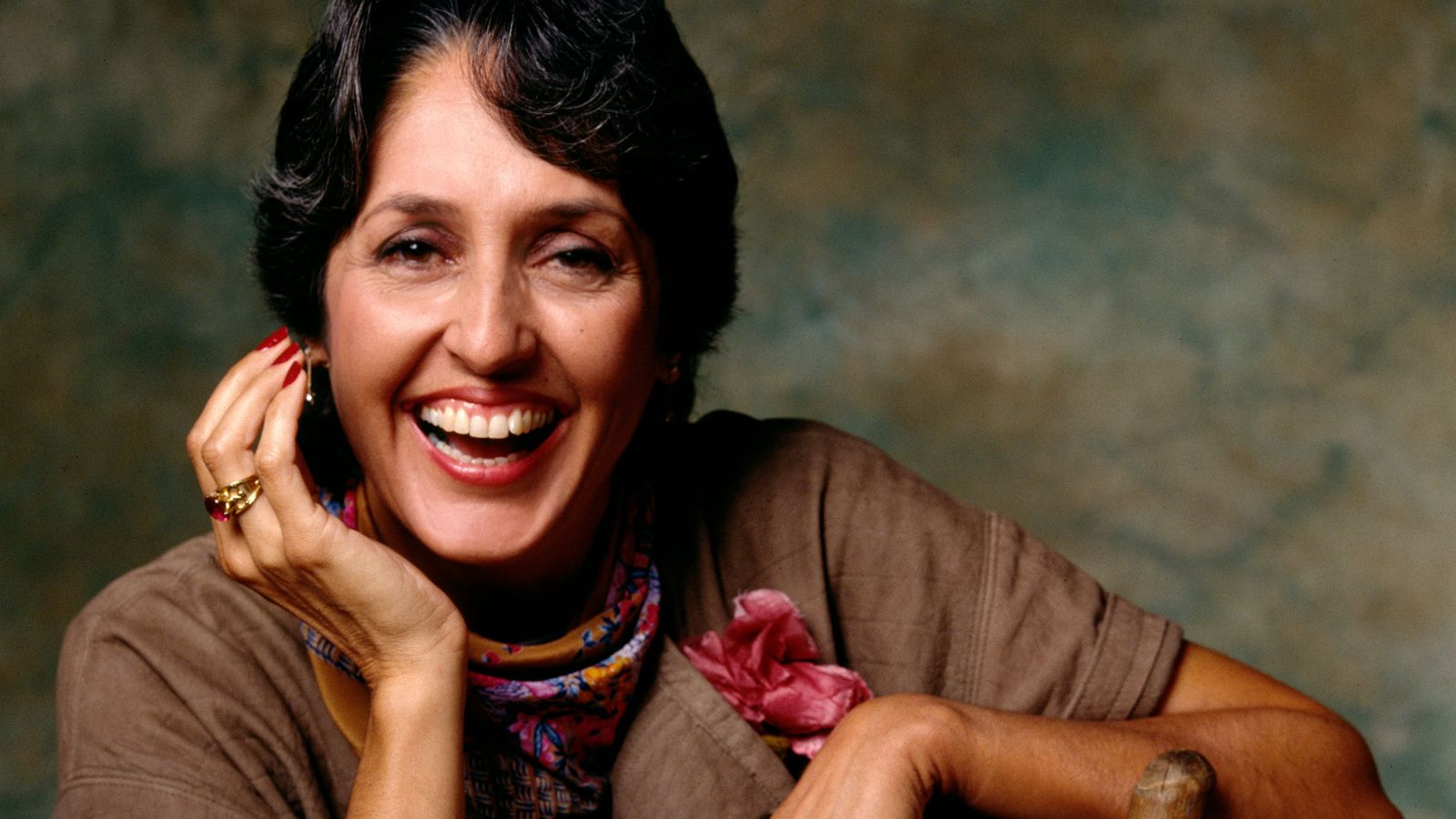 joan baez on a blue and green background