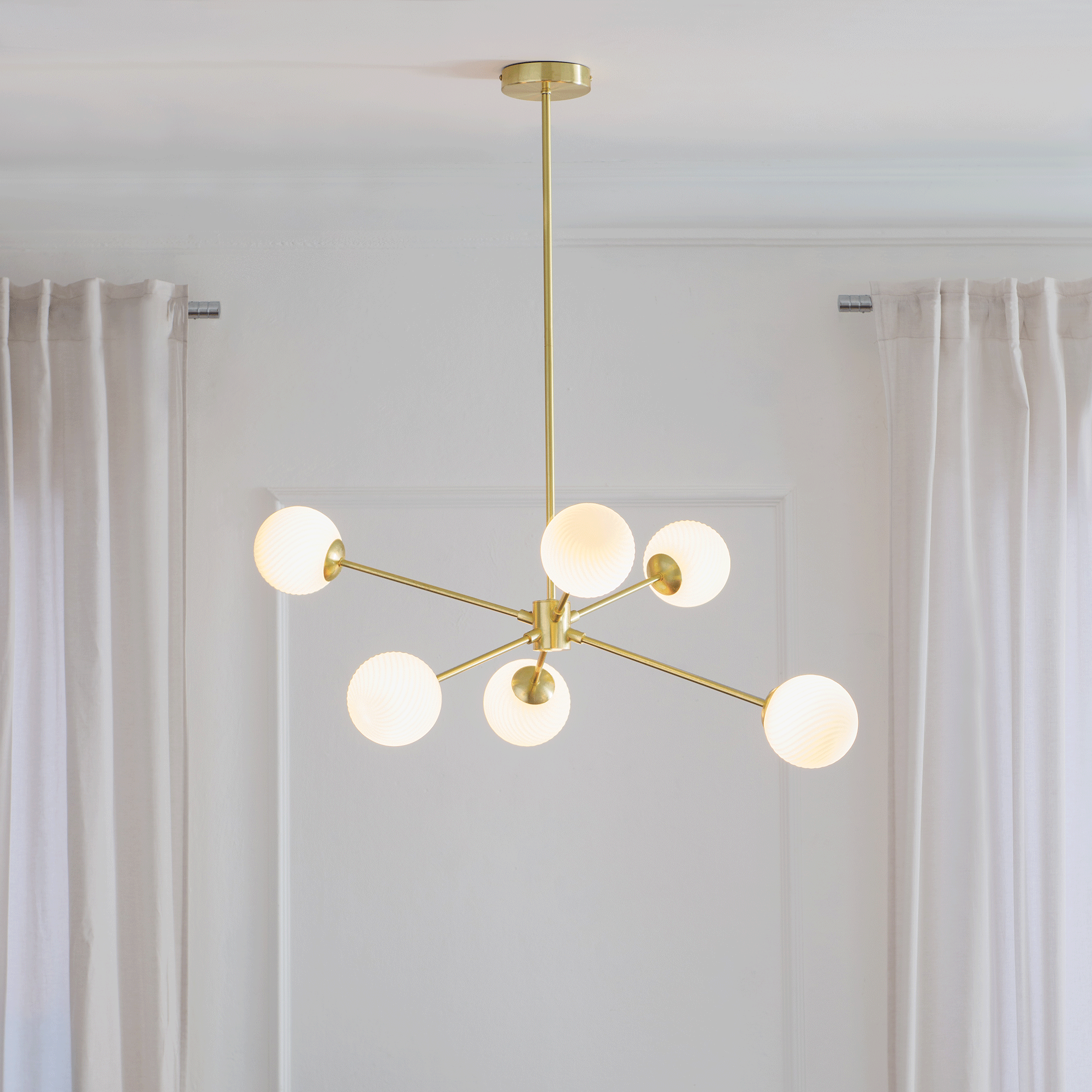 Next gold statement light in a white room